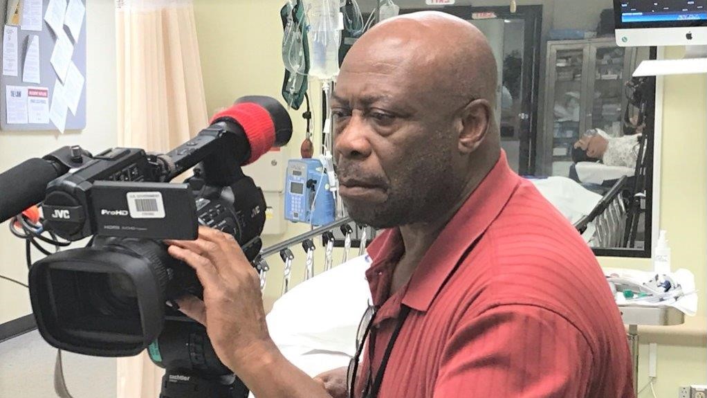 Videographer Rudy Marshall films activity in the Noble (Hospital) Training Facility's Emergency Room.